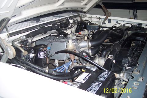 1990 Ford Bronco - Close-up view of the engine bay of a vehicle.