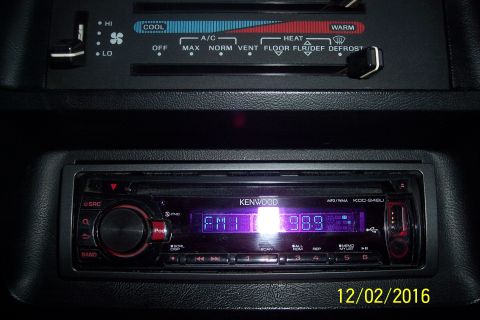 1990 Ford Bronco - The interior of a vehicle shows the climate controls and a Kenwood car stereo. The stereo display shows "FM1 98.8" and the date "12/02/2016…