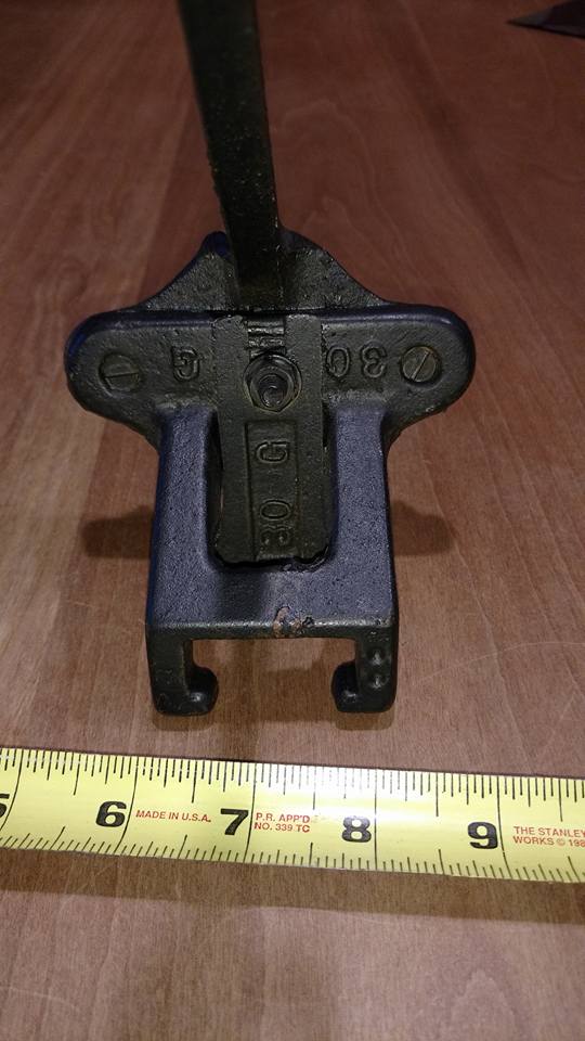 Metal clamp with "30 G" and "30" on a measuring tape.