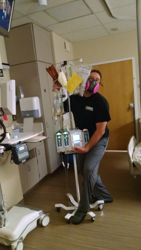 1985 Jeep CJ7 - A person wearing a mask and black t-shirt with "CRAWL" printed on it is posing with medical equipment in a hospital room.