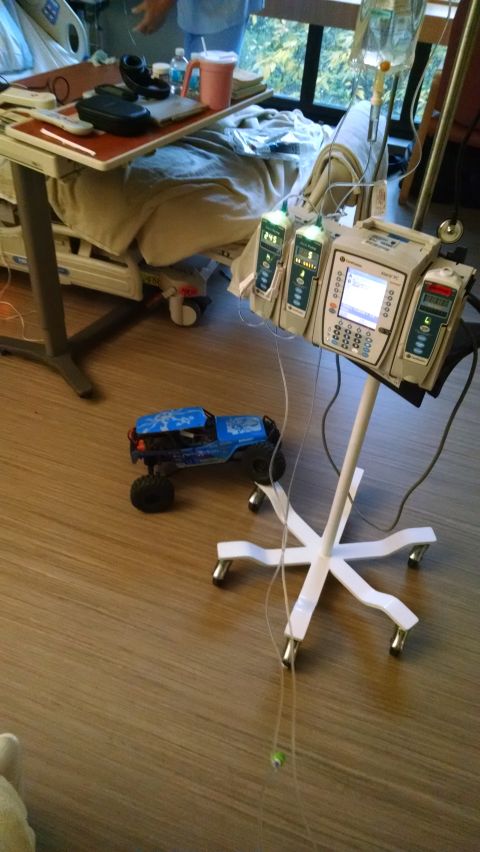 1985 Jeep CJ7 - A remote-controlled rock crawler toy truck is on the floor next to medical equipment in a hospital room.