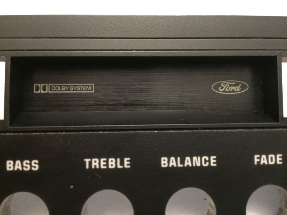 Close-up of Ford car stereo controls with Dolby System logo.