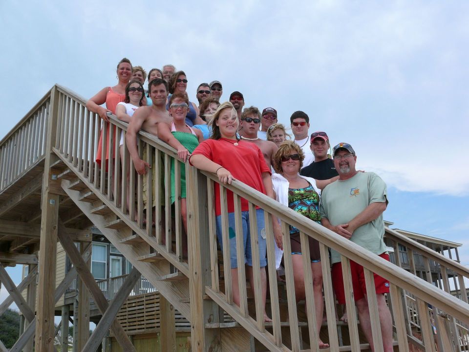Group of people on a beach house staircase