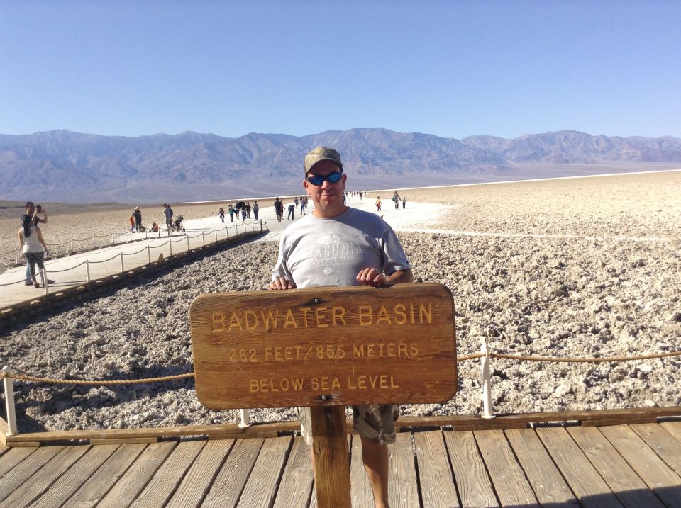 Man at Badwater Basin sign