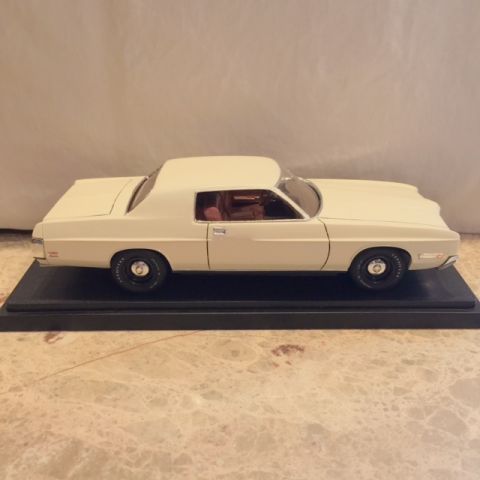 2004 Ford Crown Victoria - Model of a 1970s sedan, likely a Ford, displayed on a black base.