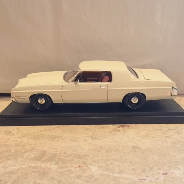 Model car, cream colored, on black display base