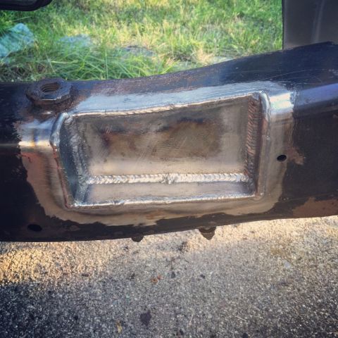 2004 Ford Crown Victoria - A section of a vehicle's frame shows a freshly welded patch, indicating a repair has been made.
