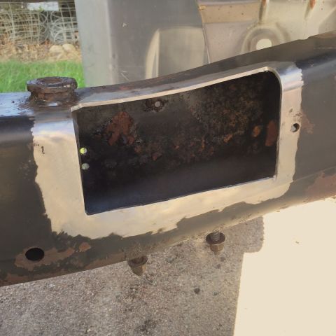 2004 Ford Crown Victoria - Close-up of a vehicle frame section with a cut-out, revealing rust and recent metalwork.