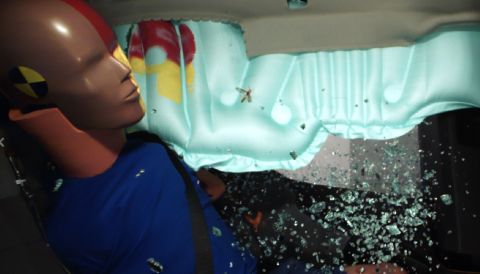 1971 Ford Ranchero - A crash test dummy is shown inside a vehicle after an airbag deployment and windshield impact.