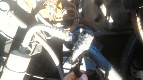 1992 Ford Bronco - Damaged hose in engine bay, wrapped with tape for temporary repair.