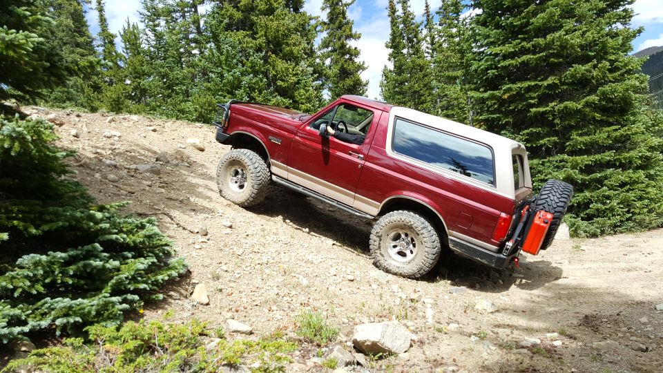 Red 1996 Ford Bronco on a dirt trail