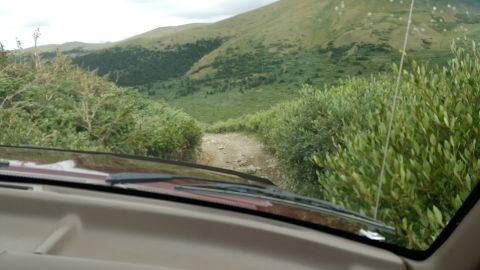 1996 Ford Bronco - Driving a 1996 Ford Bronco on a dirt road through a scenic mountain landscape.