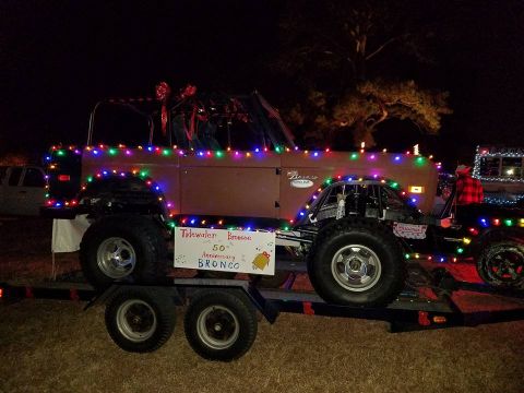 1972 Ford Bronco - This 1972 Ford Bronco, celebrating its 50th anniversary, is adorned with colorful Christmas lights and displayed on a trailer.