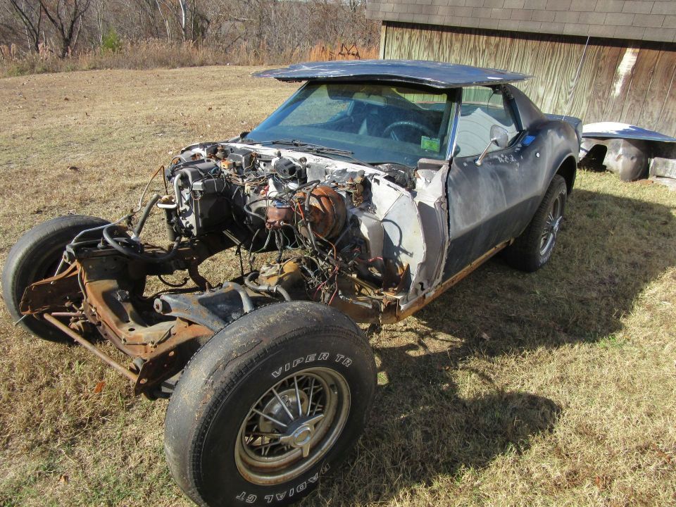 1976 Chevrolet Corvette project car with front end disassembled and body in rough condition