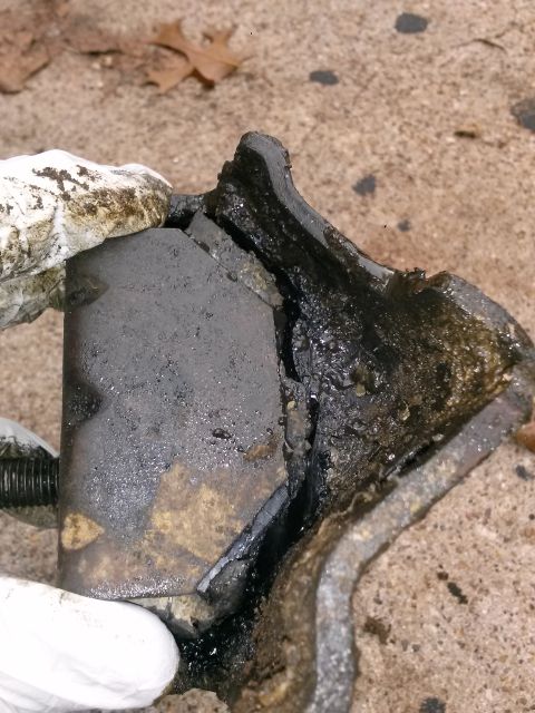 1996 Ford Bronco - A severely damaged motor mount, showing the failure of the rubber and metal components.