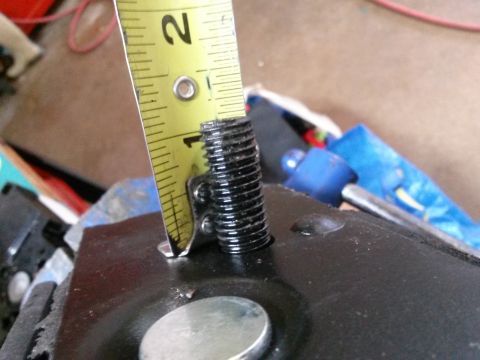 1996 Ford Bronco - A yellow measuring tape is positioned next to a threaded bolt, with the tape showing markings up to the number 2. The bolt appears to be pa…