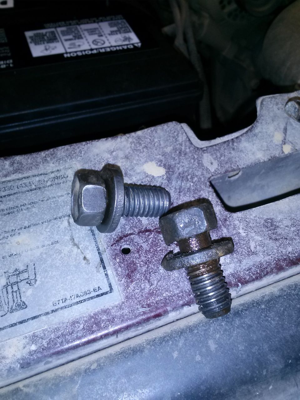 Two bolts on a dusty surface