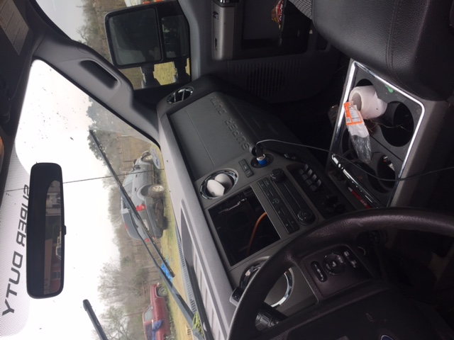 Interior of a Ford Super Duty pickup truck showing dashboard, steering wheel, and center console.