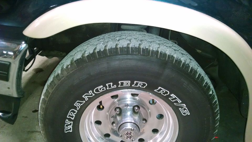 Close-up of a 1995 Ford C-150 (Centurion Conversions) wheel with Wrangler RT/S tire and beige fender flare