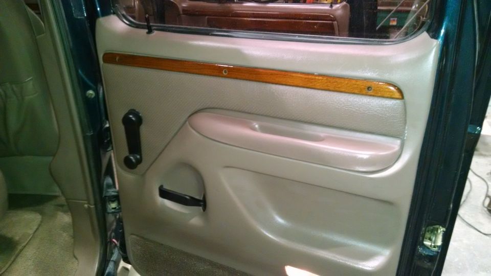1995 Ford C-150 (Centurion Conversions) interior door panel with wood trim and tan upholstery