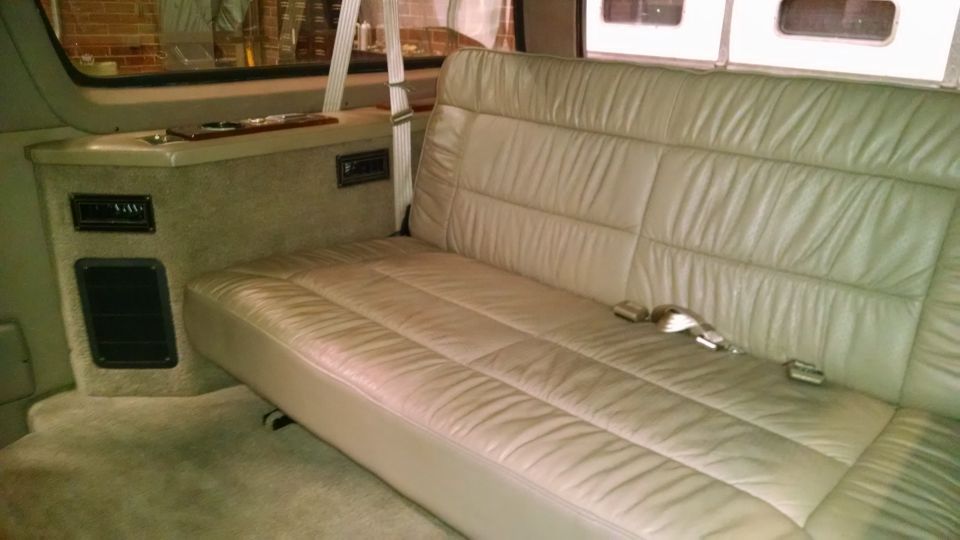 Interior with beige leather bench seat and console with vents