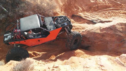 1979 Ford Bronco - Custom buggy navigates a challenging off-road trail with steep sandy ascents.