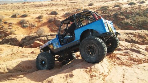 1979 Ford Bronco - A modified Jeep navigates a rocky trail in a desert environment.