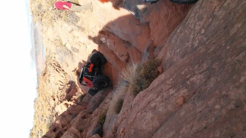 1979 Ford Bronco - An off-road vehicle navigates a challenging rocky terrain, with a person observing from above.