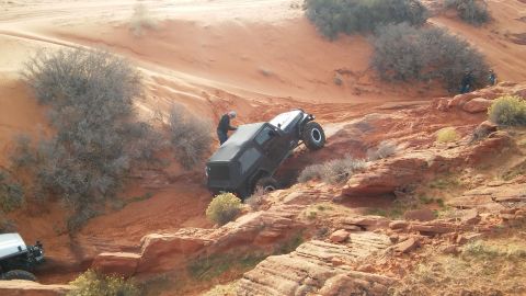 1979 Ford Bronco - Two Jeeps navigate a challenging off-road course in a desert landscape.