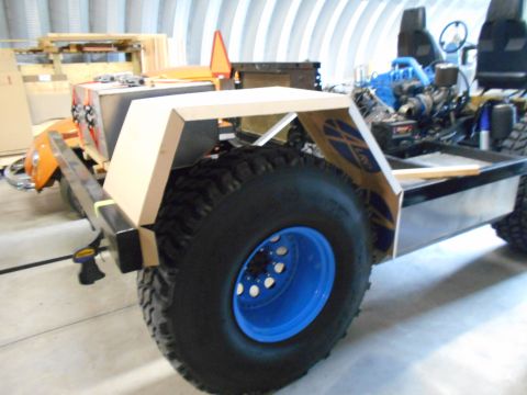 1992 Ford Bronco - A custom vehicle chassis is shown with a large tire and unfinished bodywork, lacking any visible year identification.