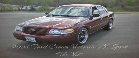 2004 Ford Crown Victoria - Maroon 2004 Ford Crown Victoria LX Sport sedan with aftermarket wheels parked outside.