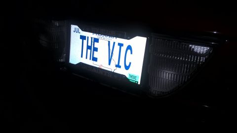 2004 Ford Crown Victoria - A license plate with the custom text "THE VIC" is illuminated on the back of a car.