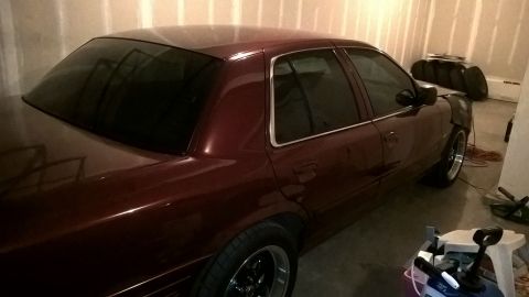 2004 Ford Crown Victoria - This maroon 2004 Ford Crown Victoria is parked in a garage, likely awaiting warmer weather.