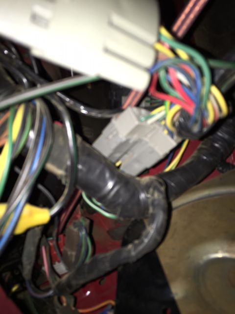 1978 Ford Bronco - Tangled vehicle wiring harness with many colored wires and connectors visible.