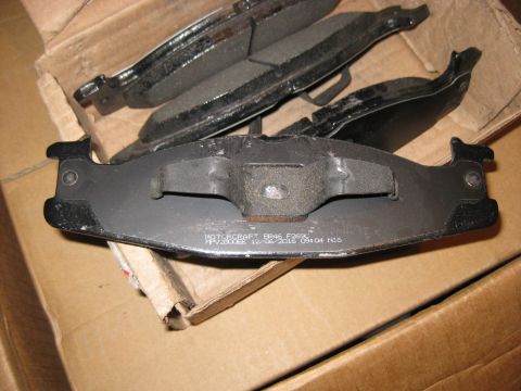 1994 Ford Bronco - New Motorcraft brake pads are shown in their packaging, ready for installation.