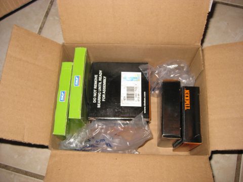 1994 Ford Bronco - Box of automotive bearings, including SKF and Timken brands, ready for installation.