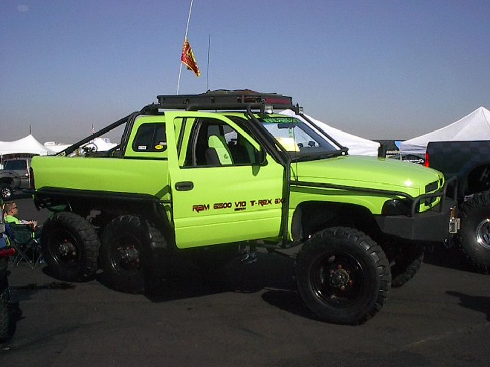 Lime-green 6-wheel Dodge Ram pickup with RAM 6300 V10 T-Rex 6X6 door graphics at outdoor show