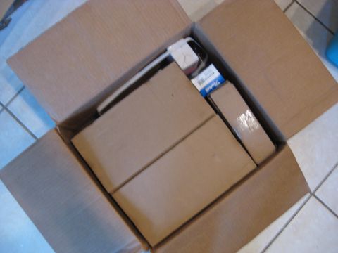 1994 Ford Bronco - Cardboard boxes filled with vehicle parts are shown from a top-down perspective.