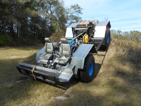 1992 Ford Bronco - This custom-built vehicle appears to be an amphibious vehicle with a unique design and exposed engine.