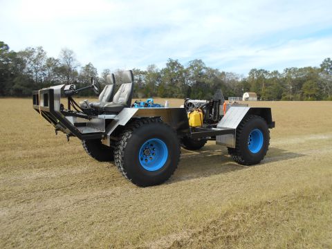 1992 Ford Bronco - This custom-built vehicle features two seats, a exposed engine, and large tires with bright blue rims.