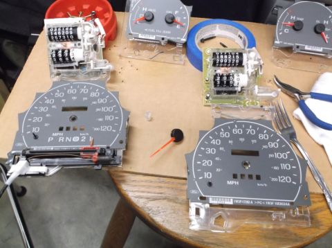 1999 Mercury Grand Marquis - Car dashboard gauges and odometer components are laid out for repair or modification.