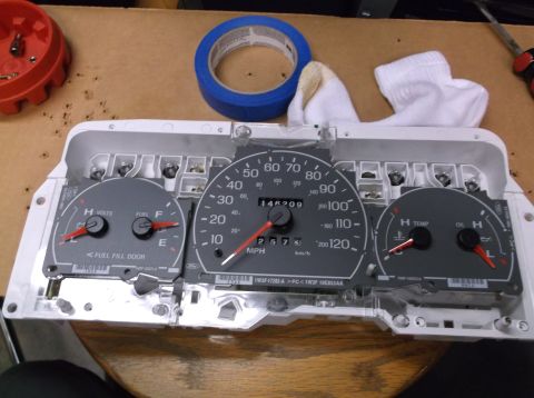 1999 Mercury Grand Marquis - Instrument cluster removed from a vehicle, showing gauges and mileage.