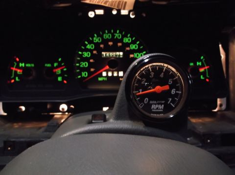 1999 Mercury Grand Marquis - The dashboard shows the speedometer, fuel gauge, voltage meter, and a newly installed tachometer.