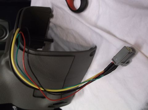 1999 Mercury Grand Marquis - Wiring harness connected to a steering column shroud, likely for an aftermarket installation.