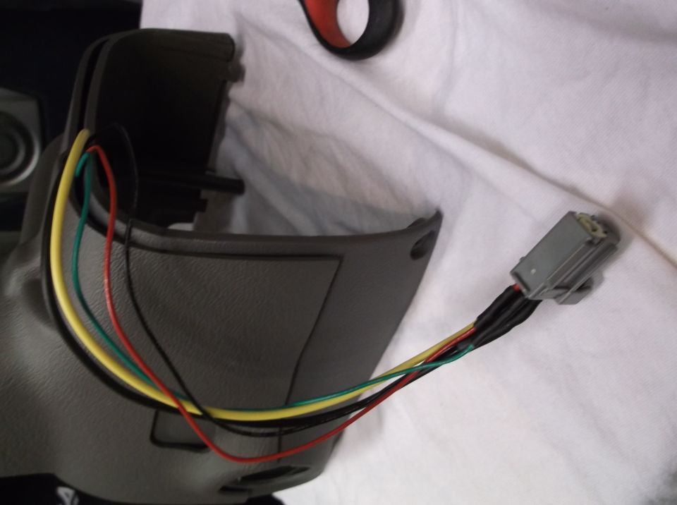 Steering column shroud with exposed wiring harness and connector