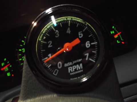 1999 Mercury Grand Marquis - Close-up of a car's dashboard showing a tachometer and fuel gauge.