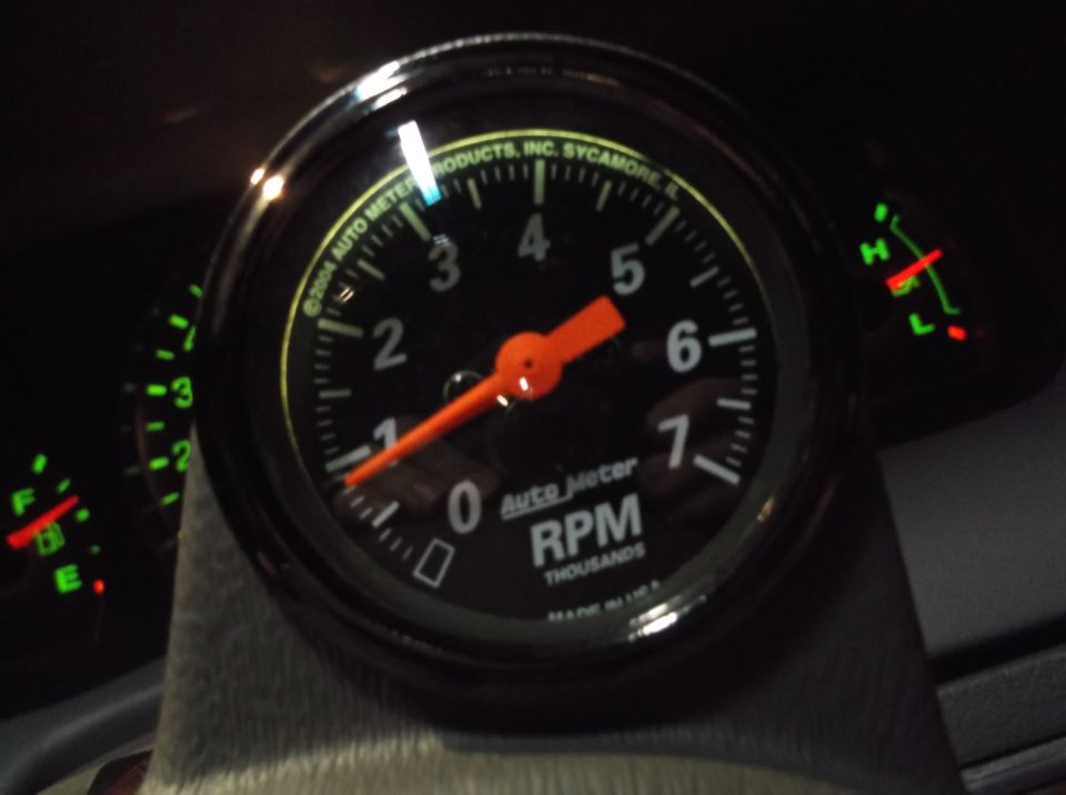 Auto Meter tachometer and fuel gauge with green and red indicators