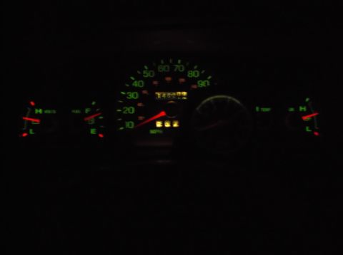 1999 Mercury Grand Marquis - The illuminated dashboard of a 1999 Mercury Grand Marquis shows a speedometer reading 262 mph, an odometer reading 140299, a fuel gauge, a…