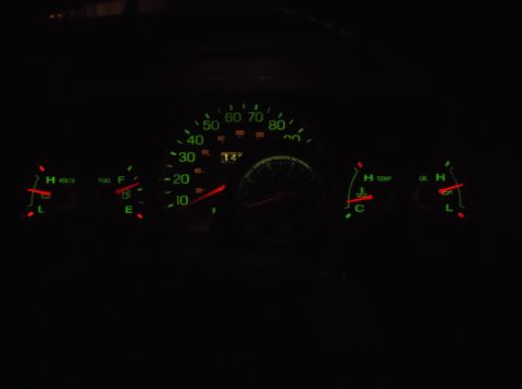 1999 Mercury Grand Marquis - The illuminated dashboard gauges of a 1999 Mercury Grand Marquis are visible in the dark. The gauges include a speedometer, fuel level, vol…