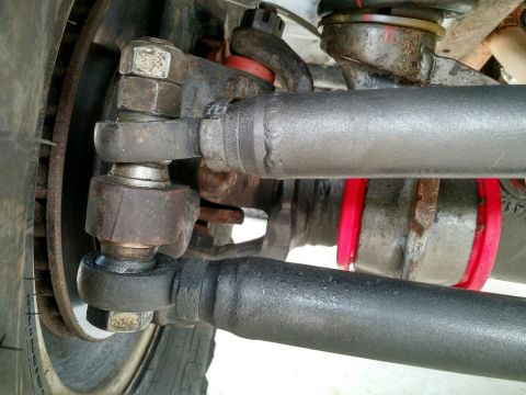 1992 Ford Bronco - This photo shows the intricate details of a vehicle's steering linkage system, including tie rods and ball joints.